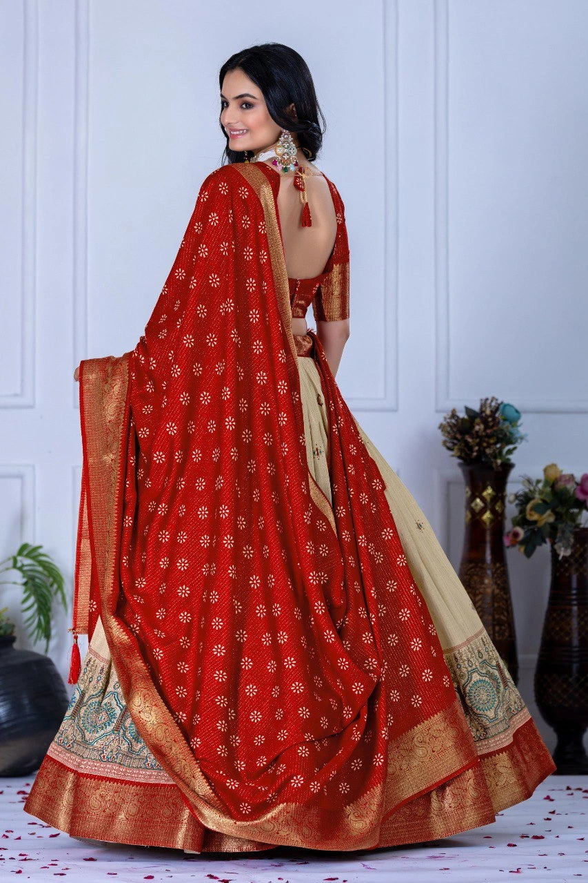 Woman wearing a red saree with gold patterns in a minimalistic setting